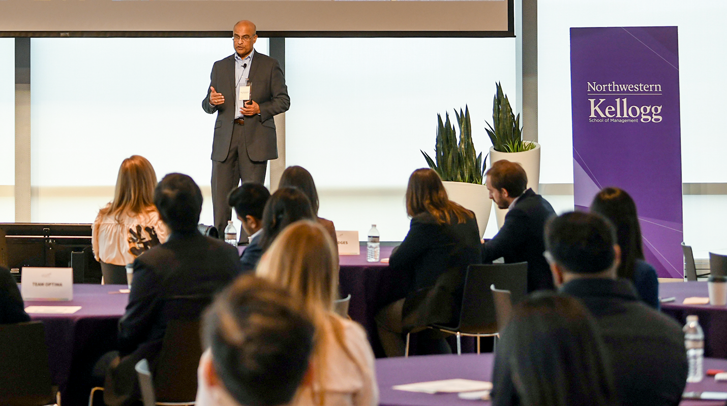 HYMH executive speaking with group of students at event.