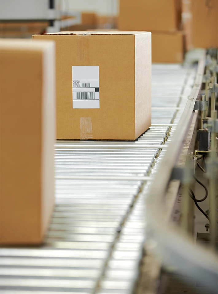 Shipping boxes on conveyer in warehouse. 