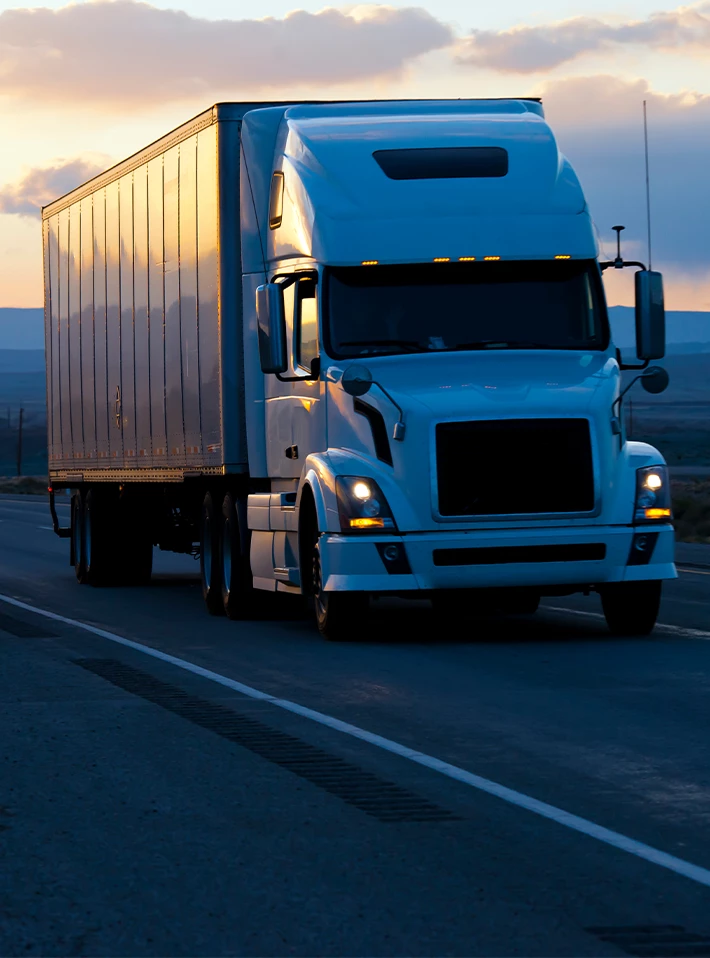 Big semi-truck with trailer moving on the road. 