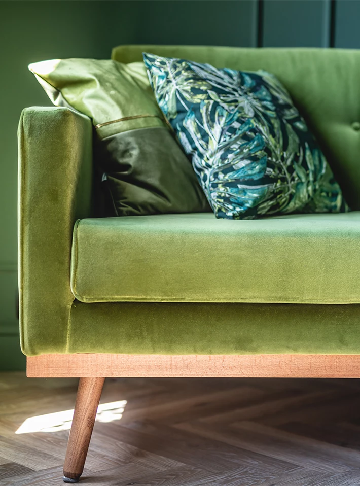 Green sofa and throw pillows. 