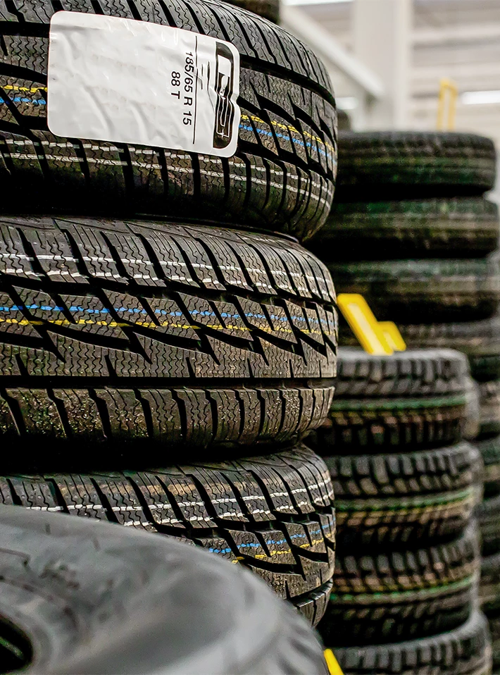 Stacks of tires in auto parts store. 