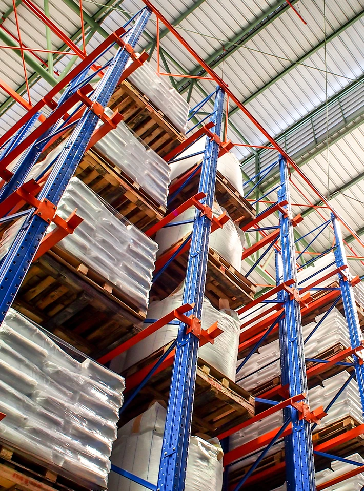 Tall warehouse racking with loads on shelves. 