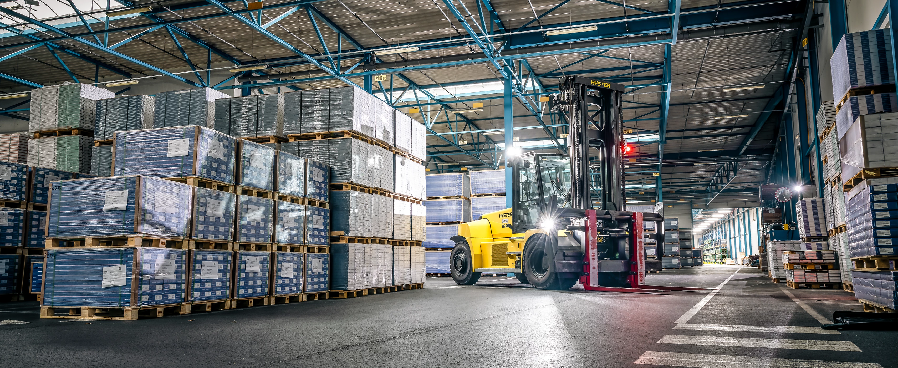 Hyster electric high-capacity truck in an industrial warehouse.