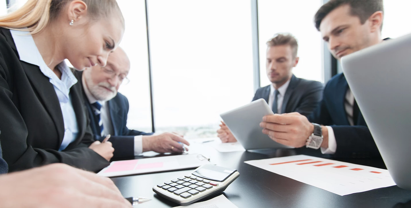 Businesspeople looking at financing figures. 