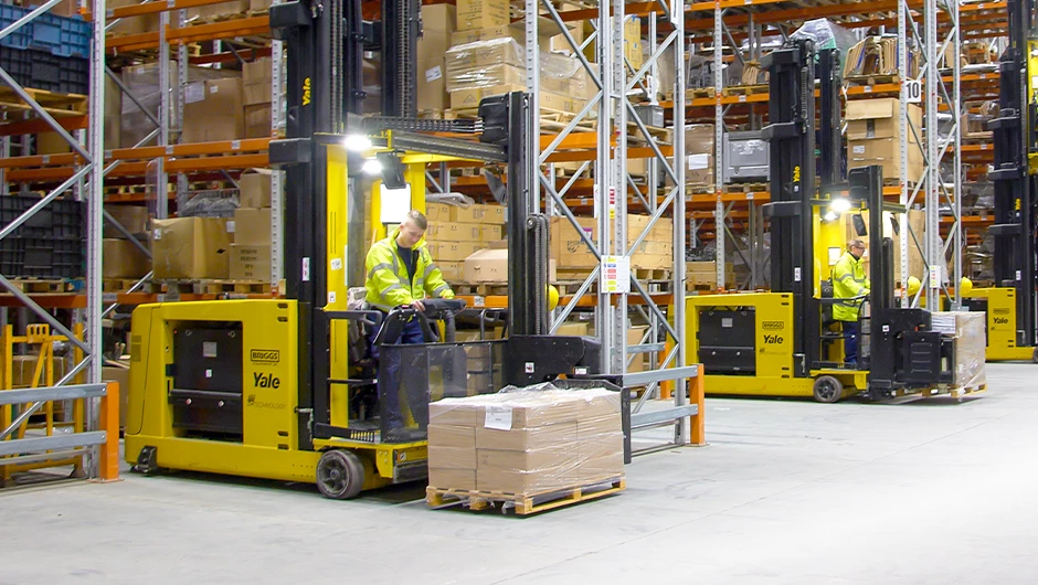 Series of Yale very narrow aisle (VNA) trucks in a warehouse.