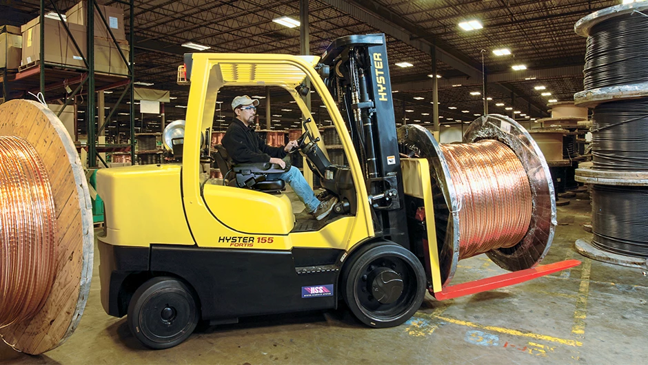 Hyster ICE cushion tire truck transporting large coil.   
