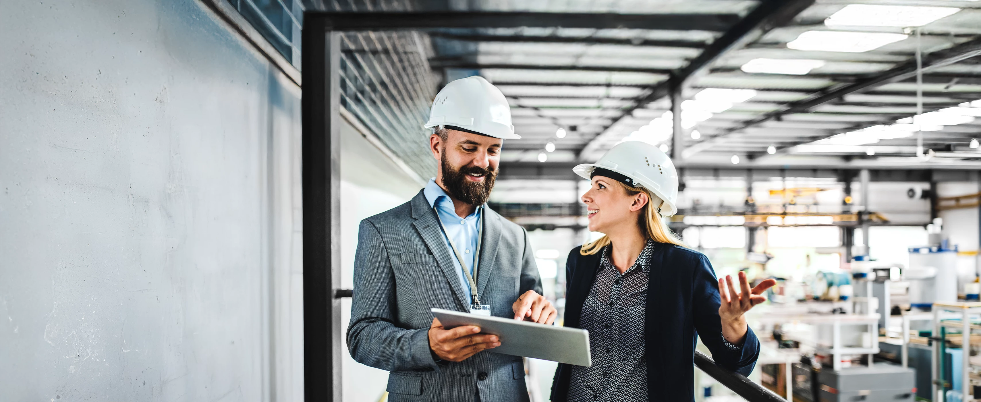 Businesspeople talking in manufacturing setting.  