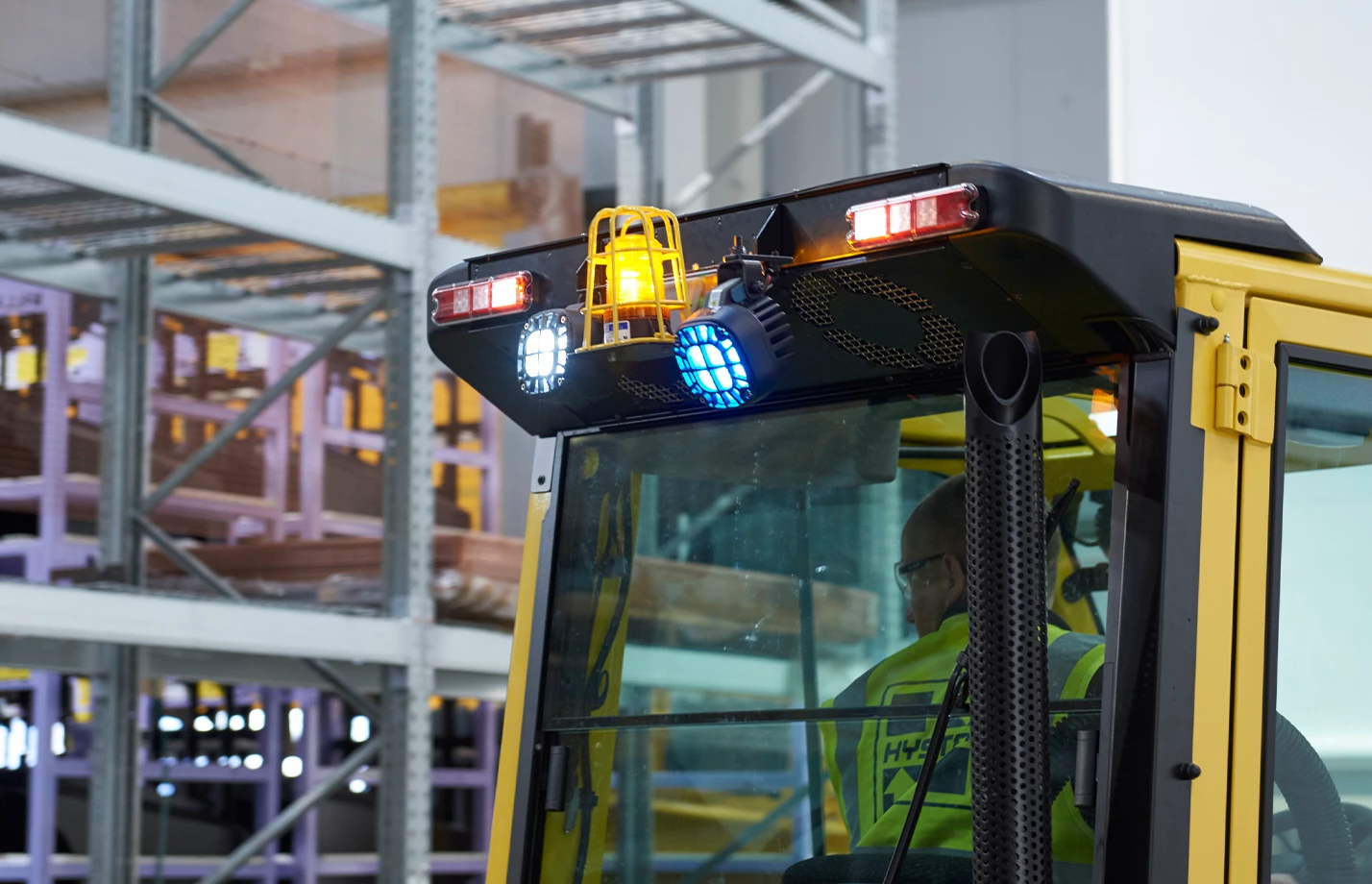 Forklift in warehouse with blue spotlight and other light options. 